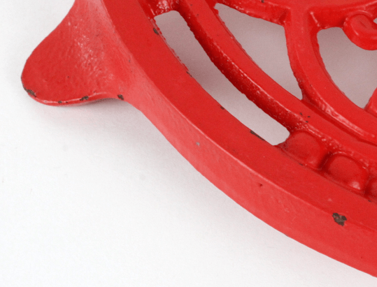 Dessous de plat vintage en fonte rouge